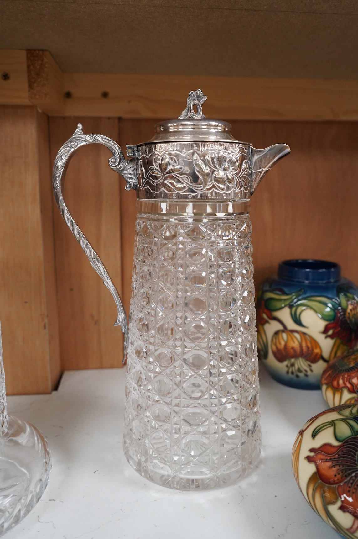 A silver plate mounted glass lemonade jug and a similar claret jug, largest 29cm high